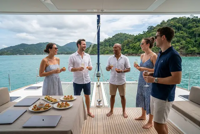 Small business team enjoying an incentive day on a sailing catamaran near Koh Samui