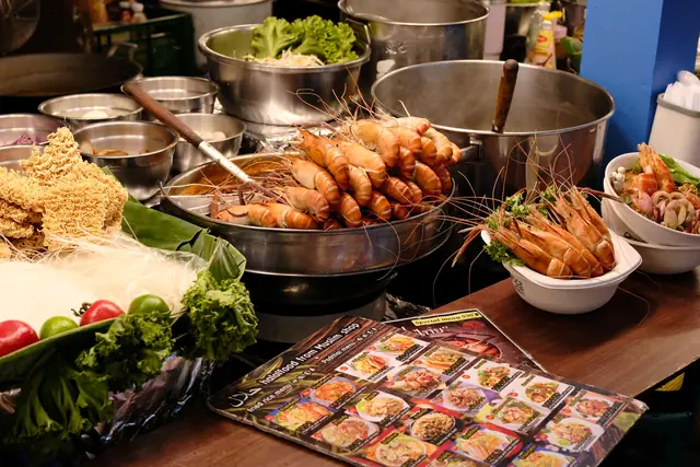 Prawns, noodles and fresh herbs laid out at a Thai street food stall