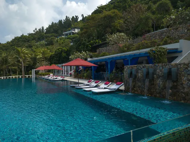 Infinity pool and sun loungers at a hillside resort on Koh Samui